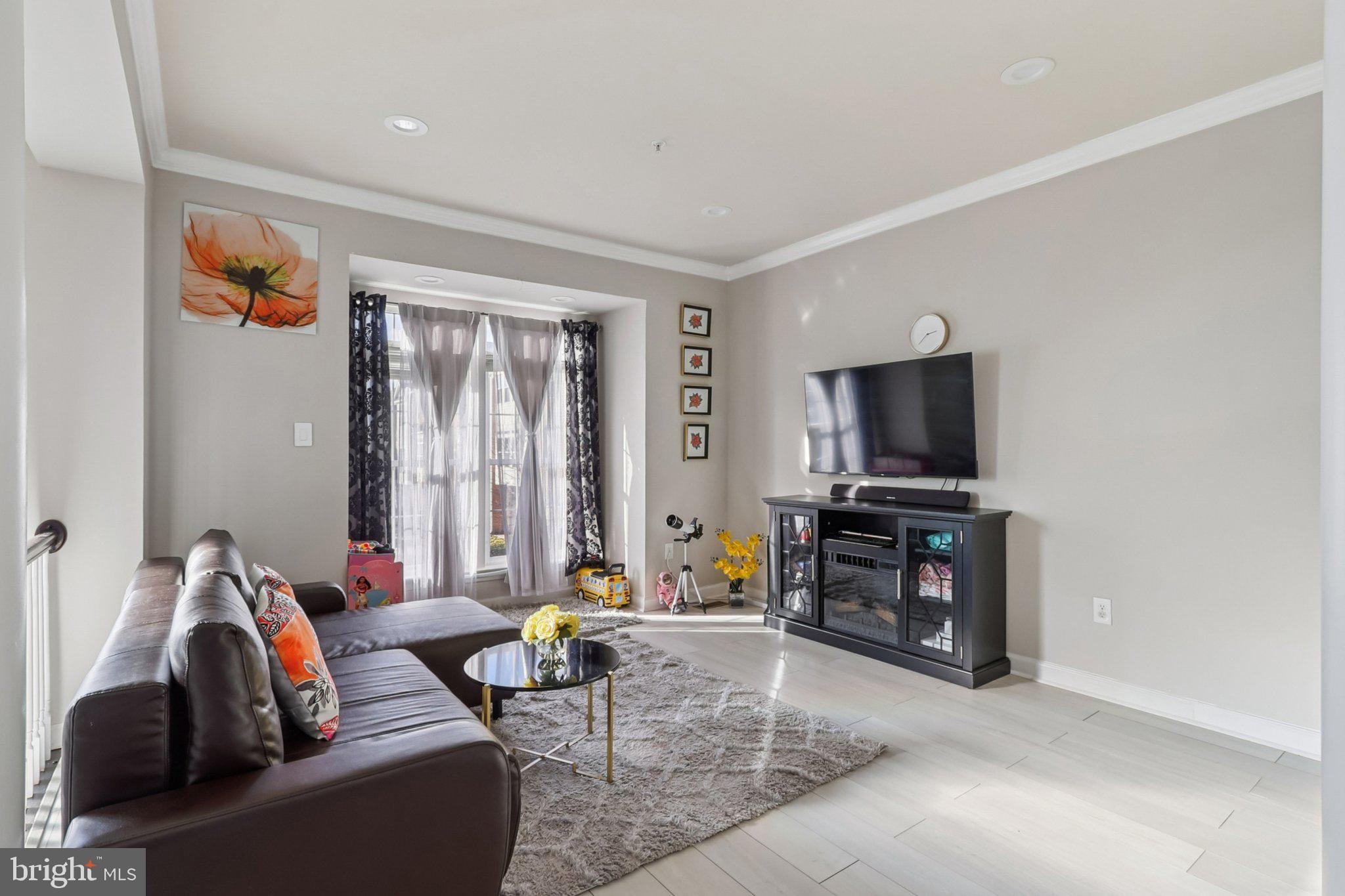 14209 Parker Farm Way Silver Spring, MD 20906 - Photo 11 of 57 a living room with furniture and a flat screen tv