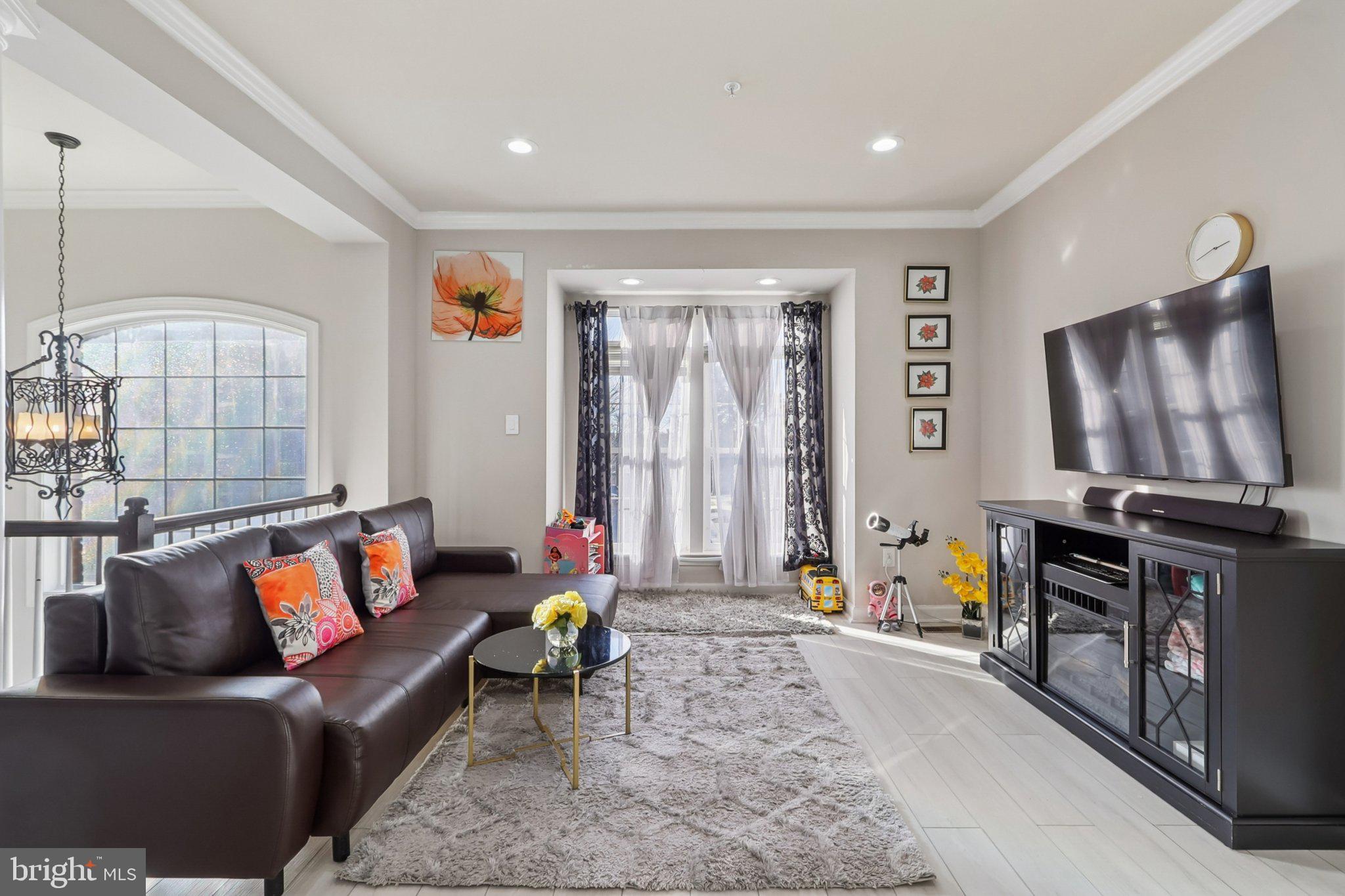 14209 Parker Farm Way Silver Spring, MD 20906 - Photo 15 of 57 a living room with furniture a flat screen tv and a window
