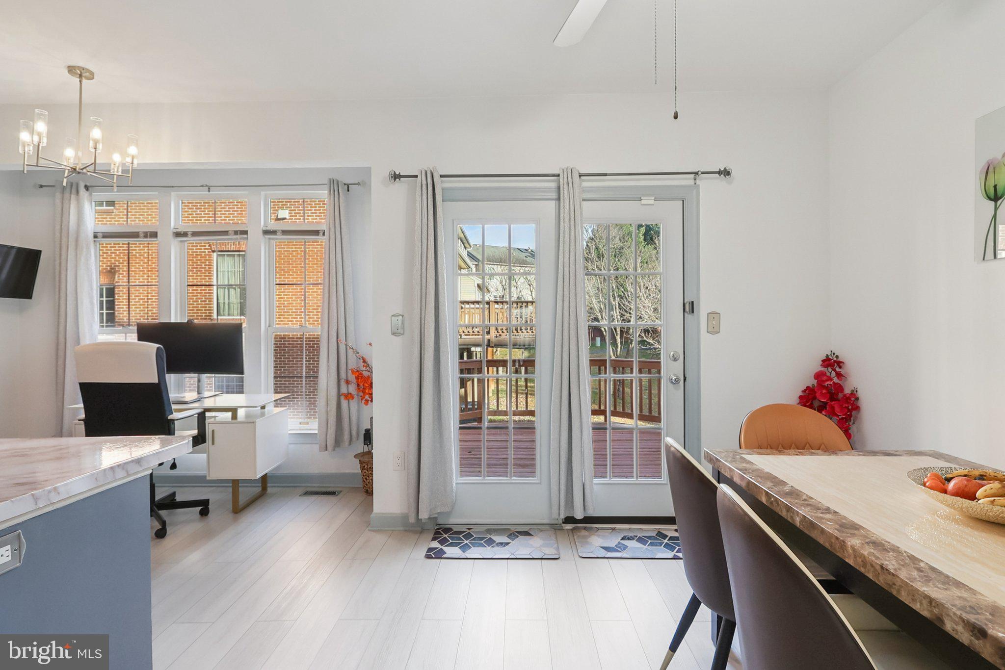 14209 Parker Farm Way Silver Spring, MD 20906 - Photo 19 of 57 a living room with furniture a flat screen tv and a floor to ceiling window
