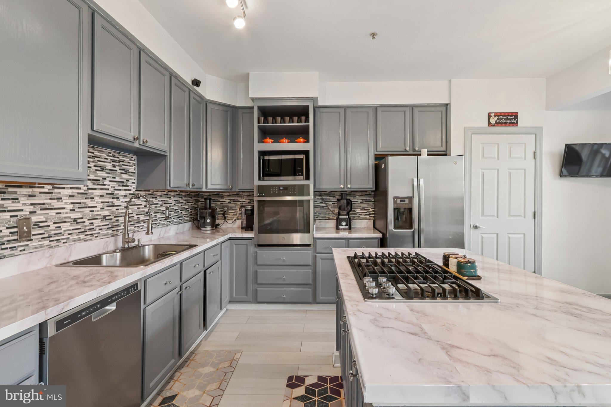 14209 Parker Farm Way Silver Spring, MD 20906 - Photo 20 of 57 a kitchen with a sink stove and refrigerator