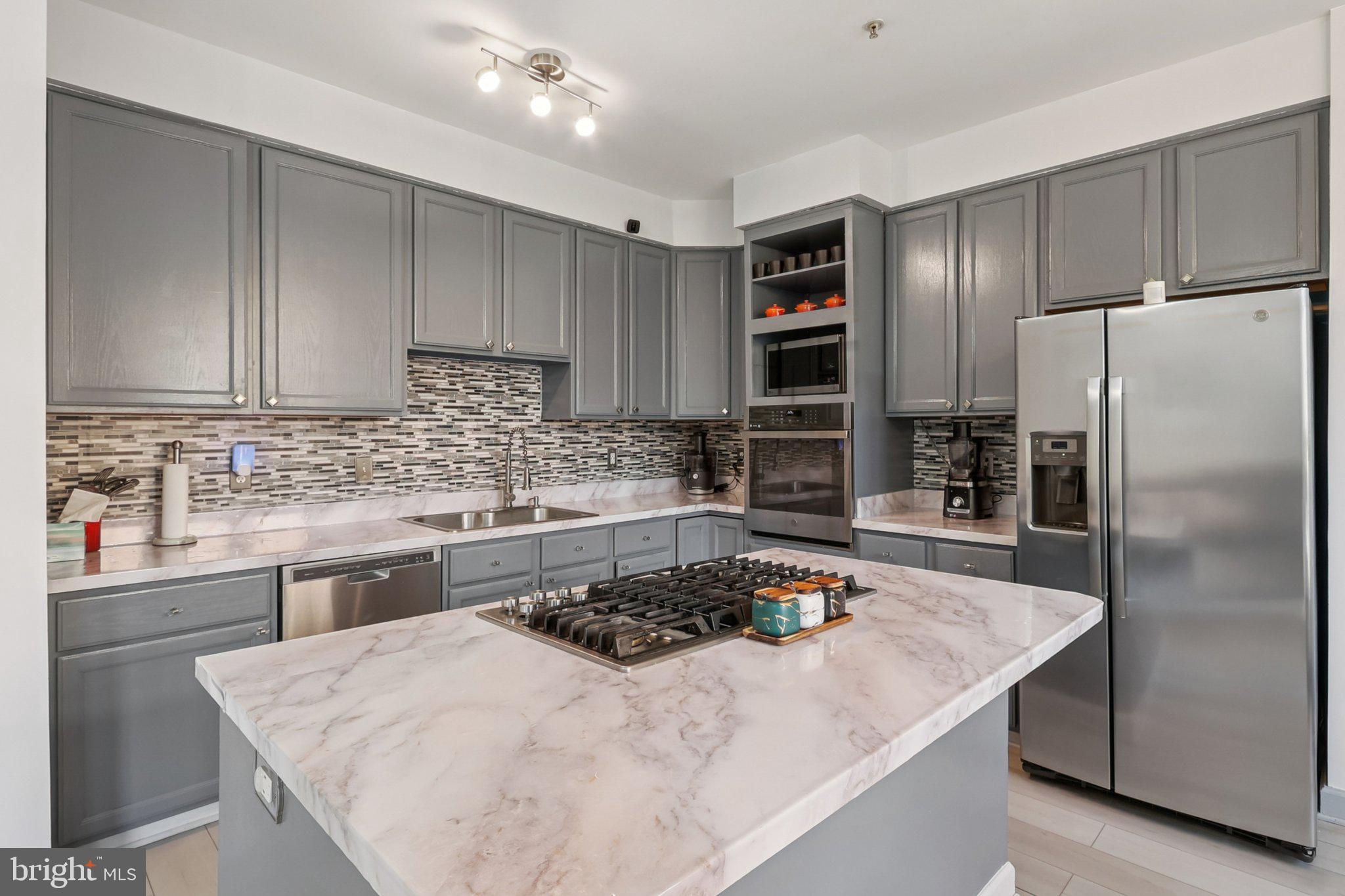 14209 Parker Farm Way Silver Spring, MD 20906 - Photo 21 of 57 a kitchen with a refrigerator sink and cabinets
