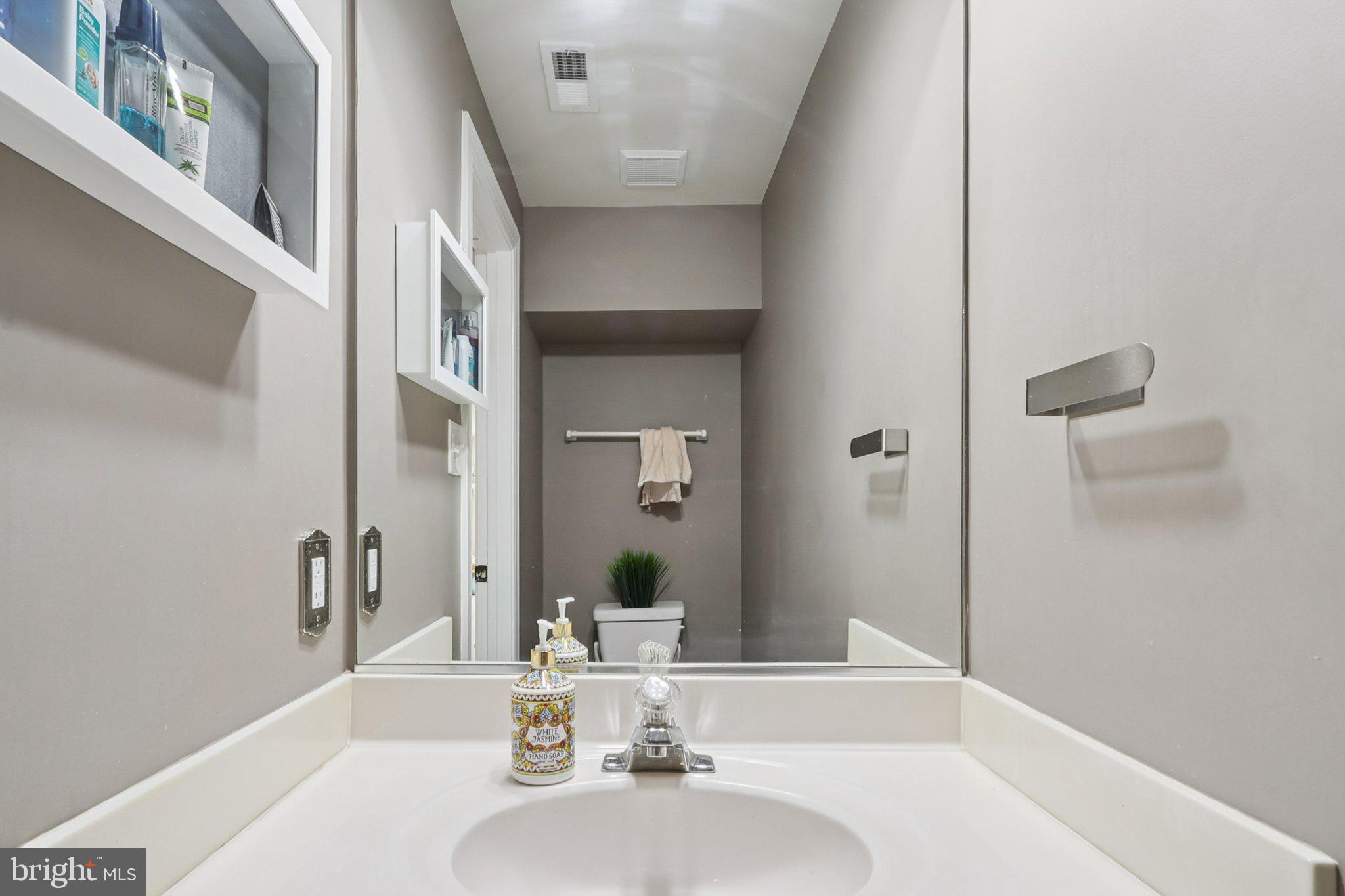 14209 Parker Farm Way Silver Spring, MD 20906 - Photo 26 of 57 a bathroom with a sink and a mirror