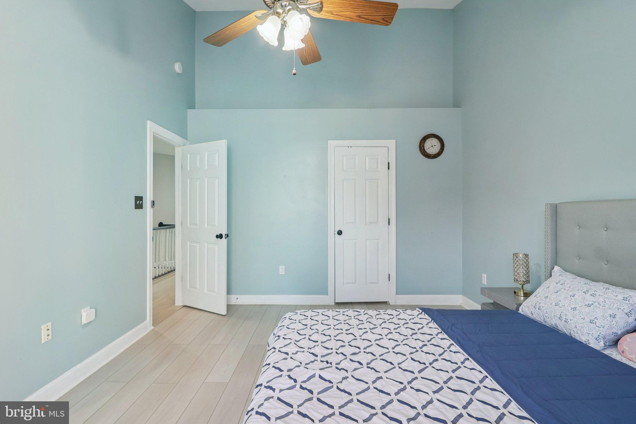 14209 Parker Farm Way Silver Spring, MD 20906 - Photo 33 of 57 a bedroom with a bed and a chandelier