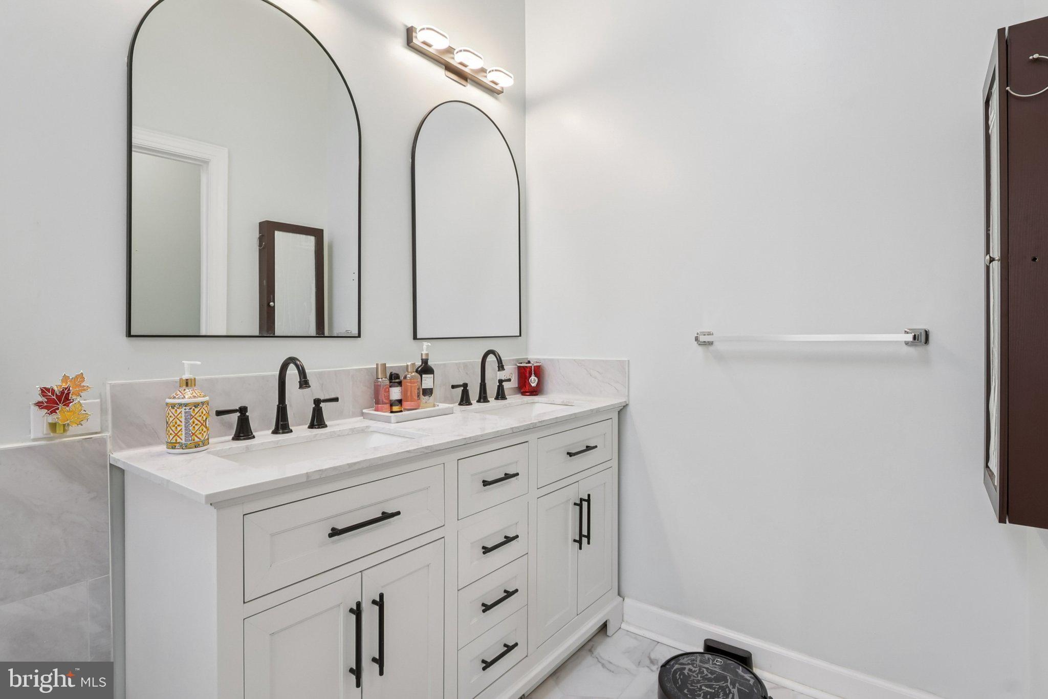 14209 Parker Farm Way Silver Spring, MD 20906 - Photo 35 of 57 a bathroom with a double vanity sink and a mirror
