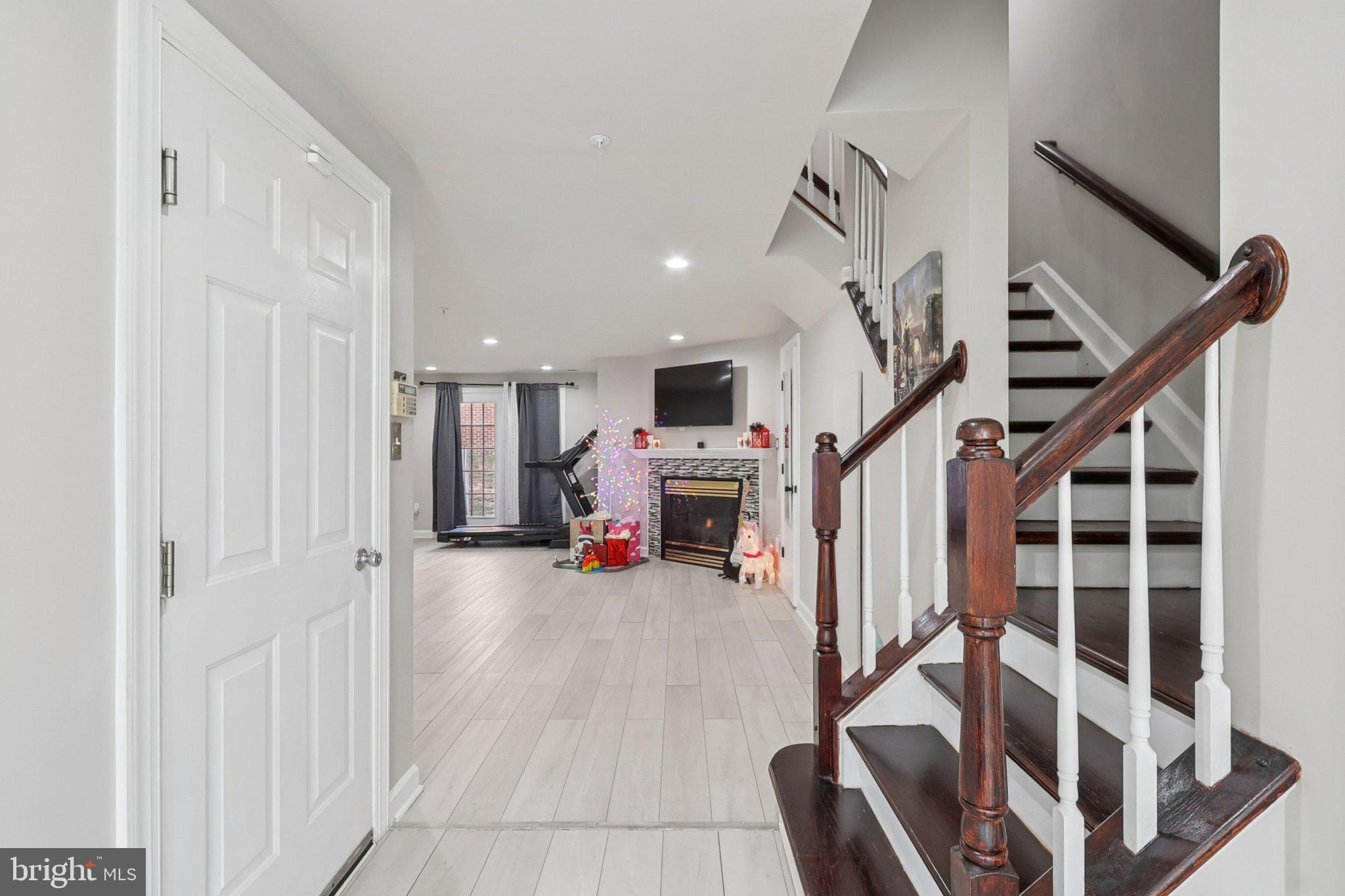 14209 Parker Farm Way Silver Spring, MD 20906 - Photo 4 of 57 a view of a livingroom with wooden floor and stairs