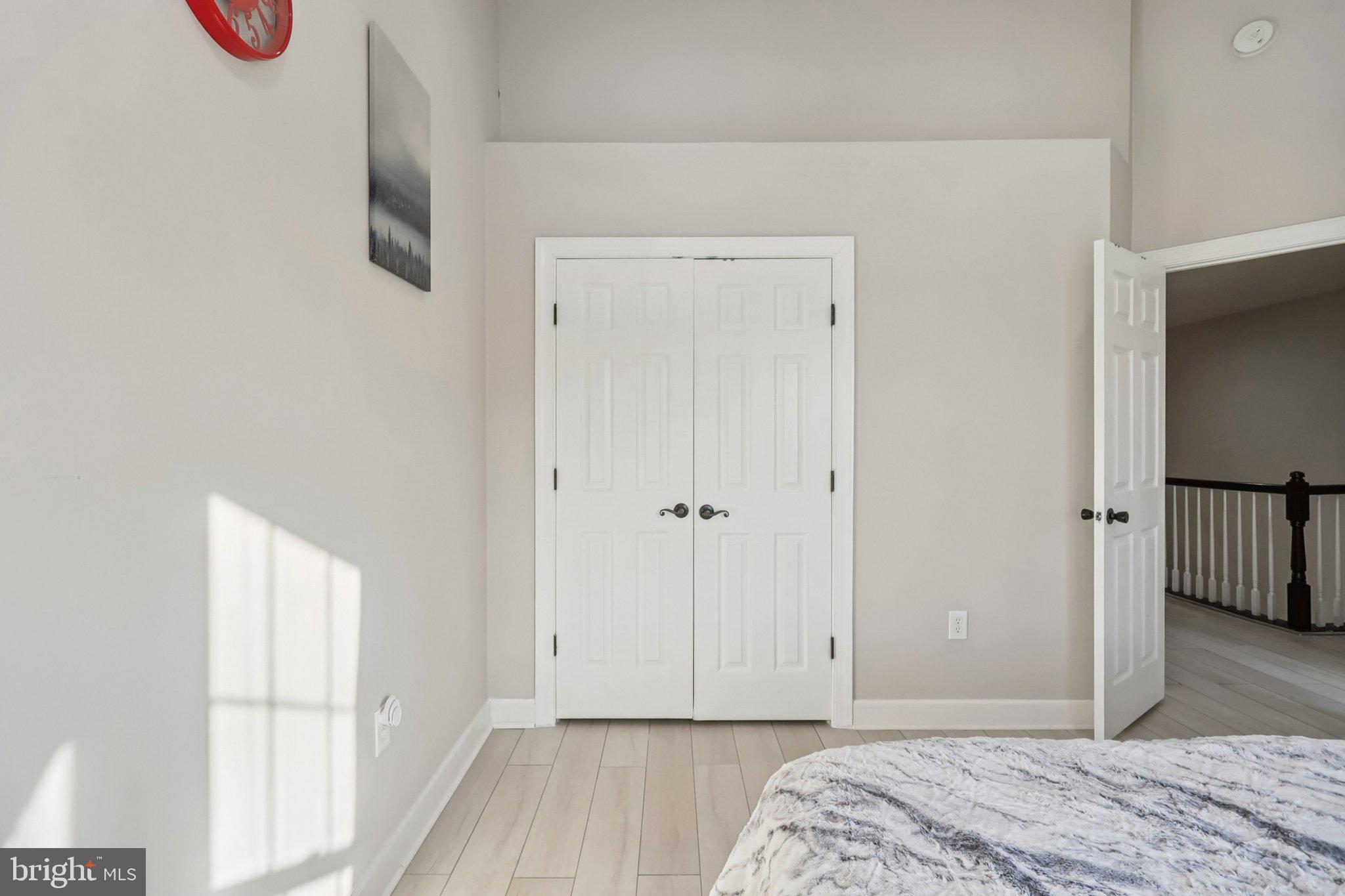 14209 Parker Farm Way Silver Spring, MD 20906 - Photo 42 of 57 a bedroom with a bed and wooden floor