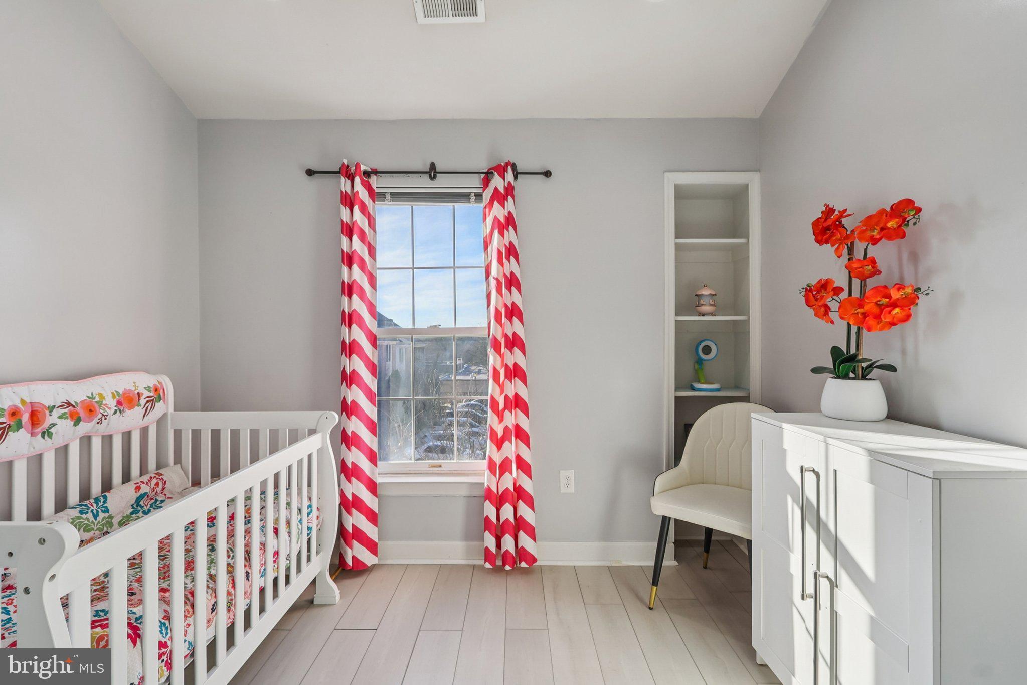14209 Parker Farm Way Silver Spring, MD 20906 - Photo 43 of 57 a bedroom with baby crib and wooden floor