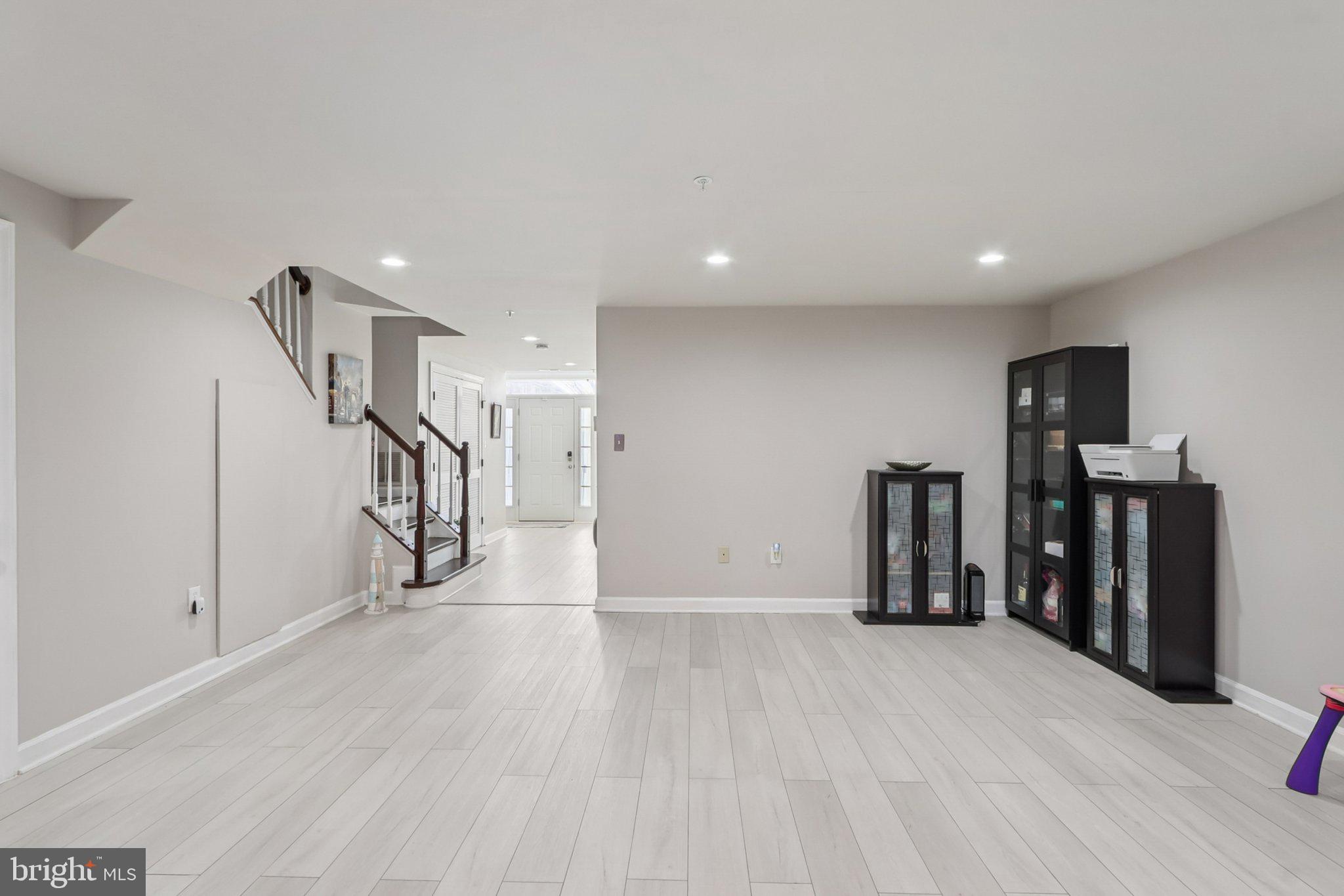 14209 Parker Farm Way Silver Spring, MD 20906 - Photo 8 of 57 a view of an empty room with wooden floor and stairs