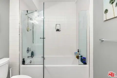 a bathroom with a bathtub with a shower