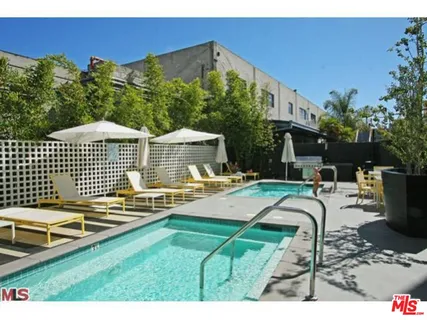 a swimming pool with outdoor seating and yard