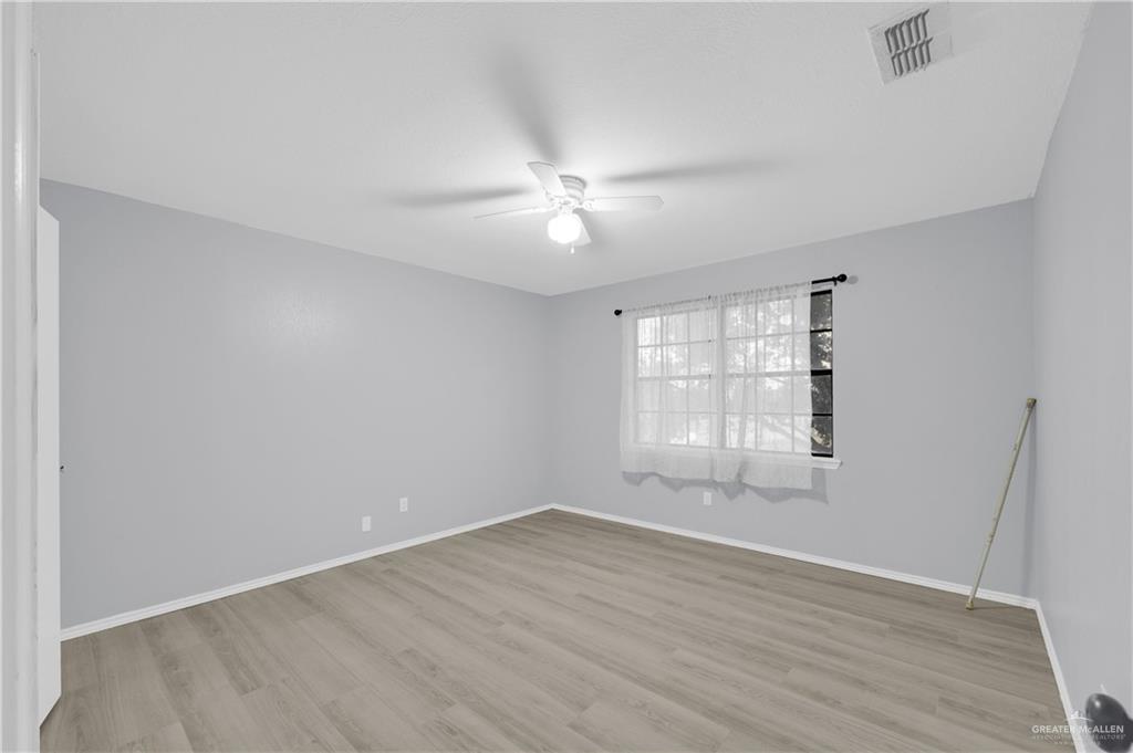 1901 Robin Avenue McAllen, TX 78504 - Photo 12 of 16 an empty room with wooden floor and windows