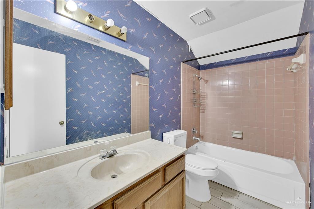 1901 Robin Avenue McAllen, TX 78504 - Photo 13 of 16 a bathroom with a sink mirror toilet and shower