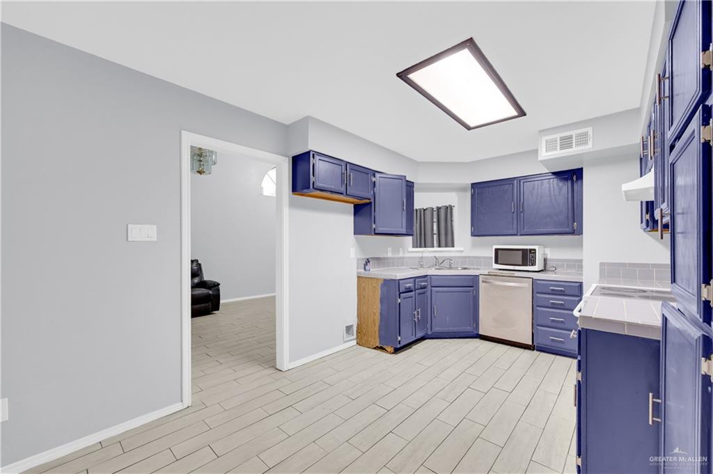 1901 Robin Avenue McAllen, TX 78504 - Photo 6 of 16 a kitchen with a refrigerator stove top oven and sink