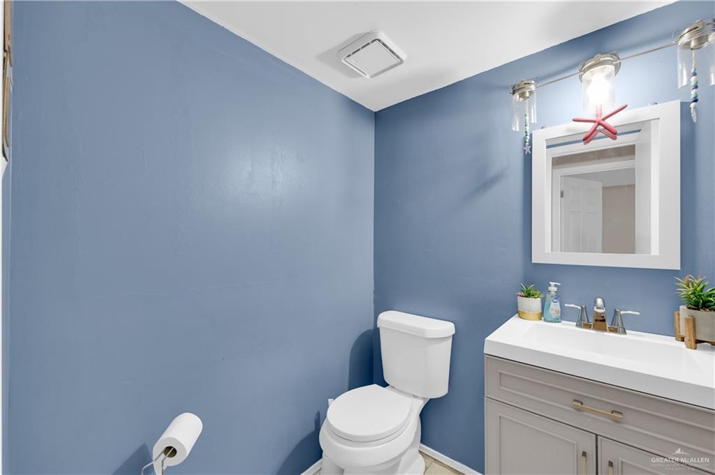 1901 Robin Avenue McAllen, TX 78504 - Photo 7 of 16 a bathroom with a toilet sink vanity and mirror