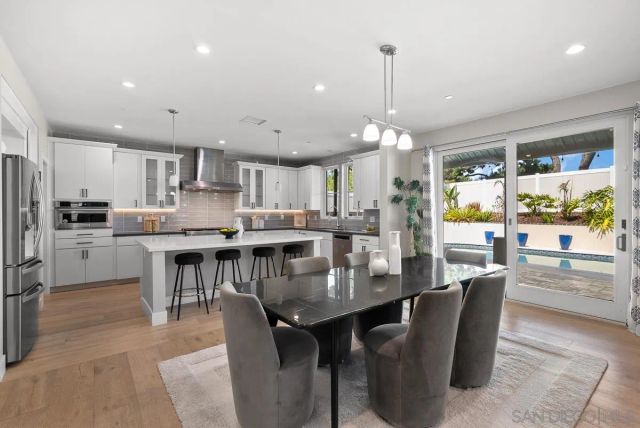 a kitchen with kitchen island granite countertop a sink a center island and stainless steel appliances