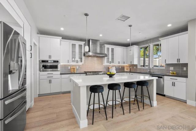 a kitchen with stainless steel appliances granite countertop a sink and cabinets