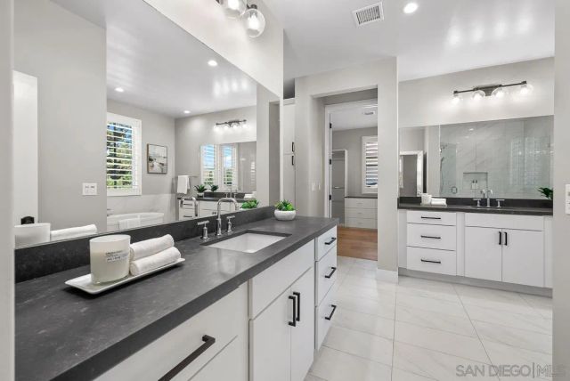a white bath tub sitting next to a shower