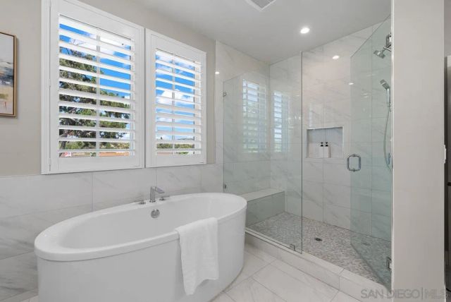 a spacious bathroom with a double vanity sink a mirror and a bathtub