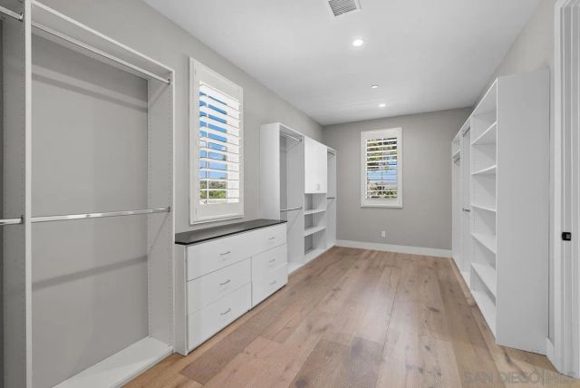 a open kitchen with white cabinets and white appliances