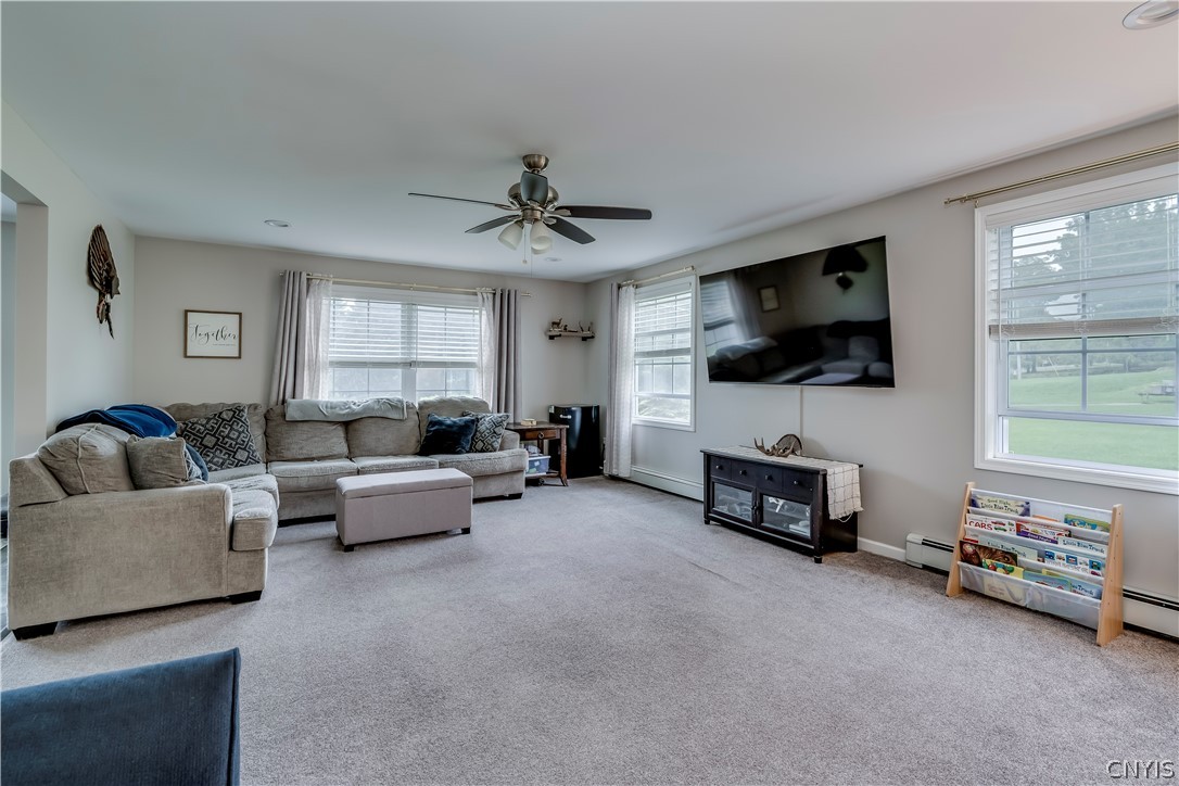 Generous windows fill this comfortable living space with abundant natural light.