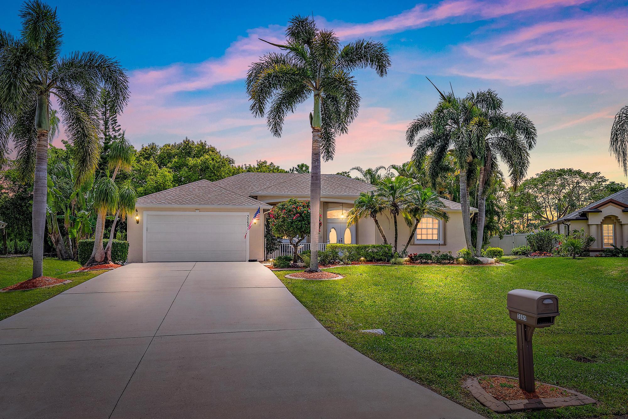 3065 Southeast Wake Road Port St. Lucie, FL 34984 - Photo 2 of 34 3065 SE Wake Rd-twilight back exterior
