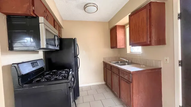a kitchen with a stove and a refrigerator