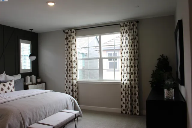 a living room with a mirror furniture and a window