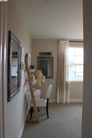 a living room with furniture kitchen and window