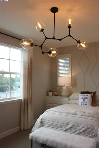 a living room with furniture a window and a mirror