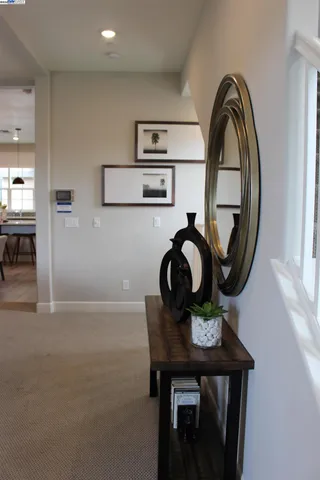 a kitchen with a table chairs refrigerator and window