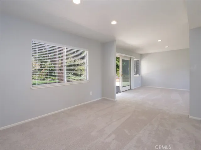 a kitchen with granite countertop wooden floors cabinets a dining table and chairs