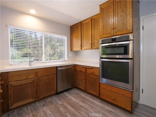 a open dining room with furniture window and wooden floor