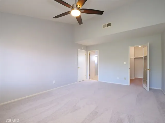 a bathroom with a granite countertop double vanity sink a mirror and a toilet