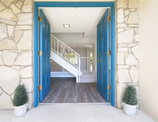 a view of an empty room with a window and fireplace