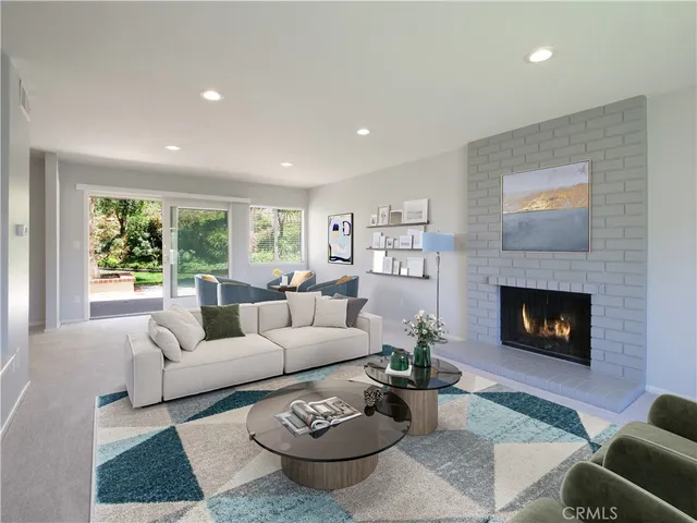 a living room with furniture potted plant and a window
