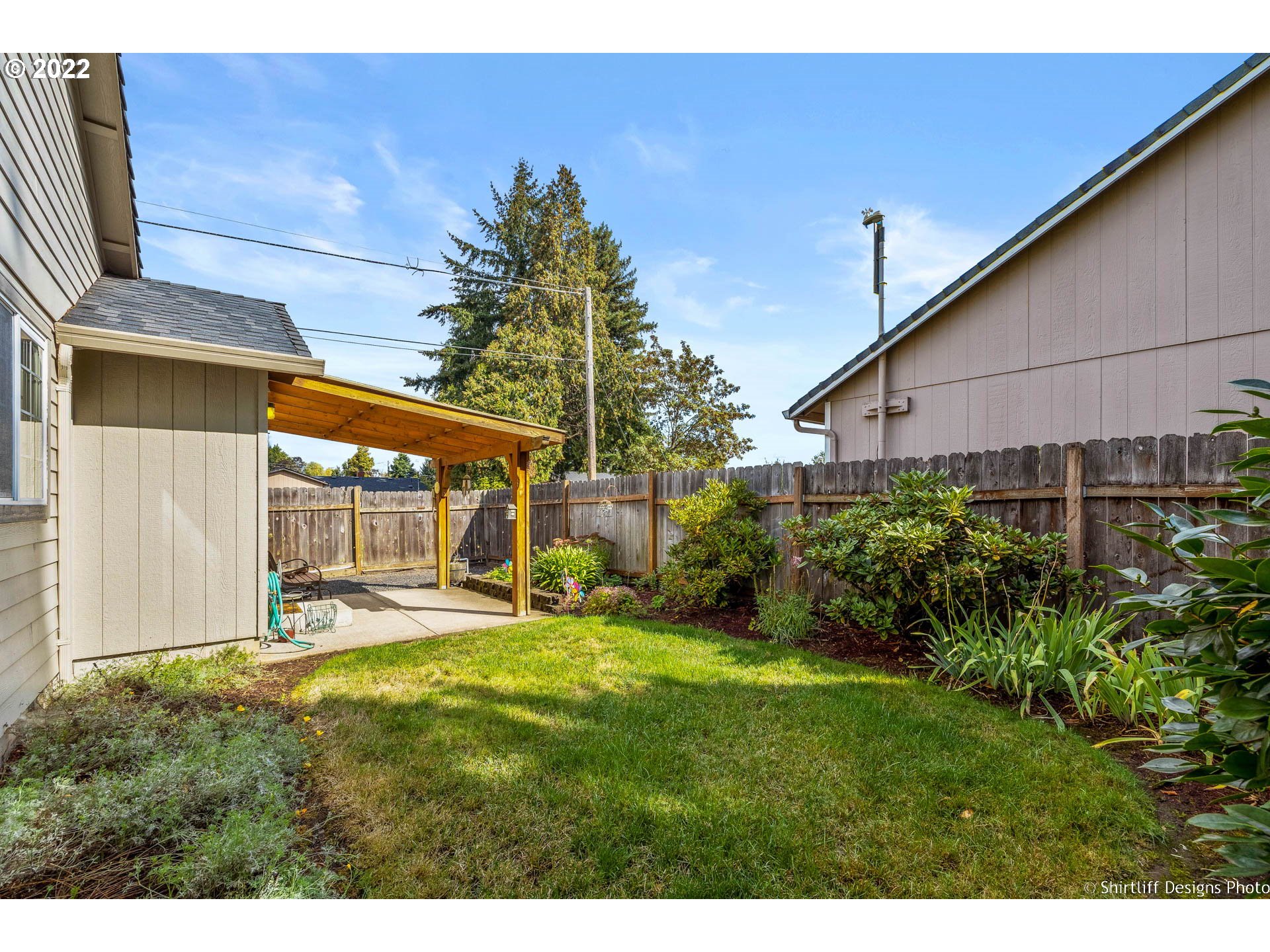 4042 Virginia Avenue Springfield, OR 97478 - Photo 24 of 28 a view of a backyard with table and chairs and potted plants