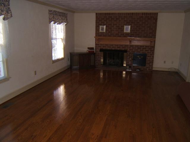 5094 Union Church Road Thaxton, VA 24174 - Photo 2 of 11 a living room with wooden floor and a fireplace