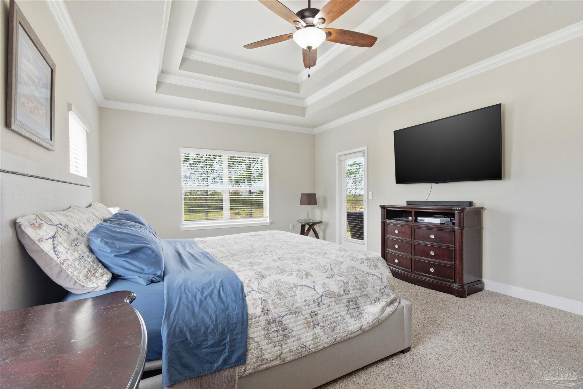 2677 Tulip Hill Road Pace, FL 32571 - Photo 21 of 35 a bedroom with a bed and a flat screen tv