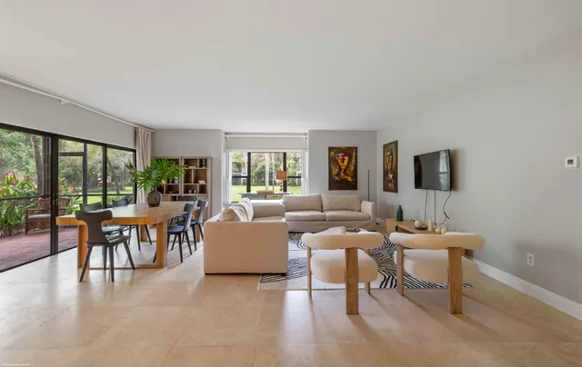 a living room with fireplace furniture and a large window