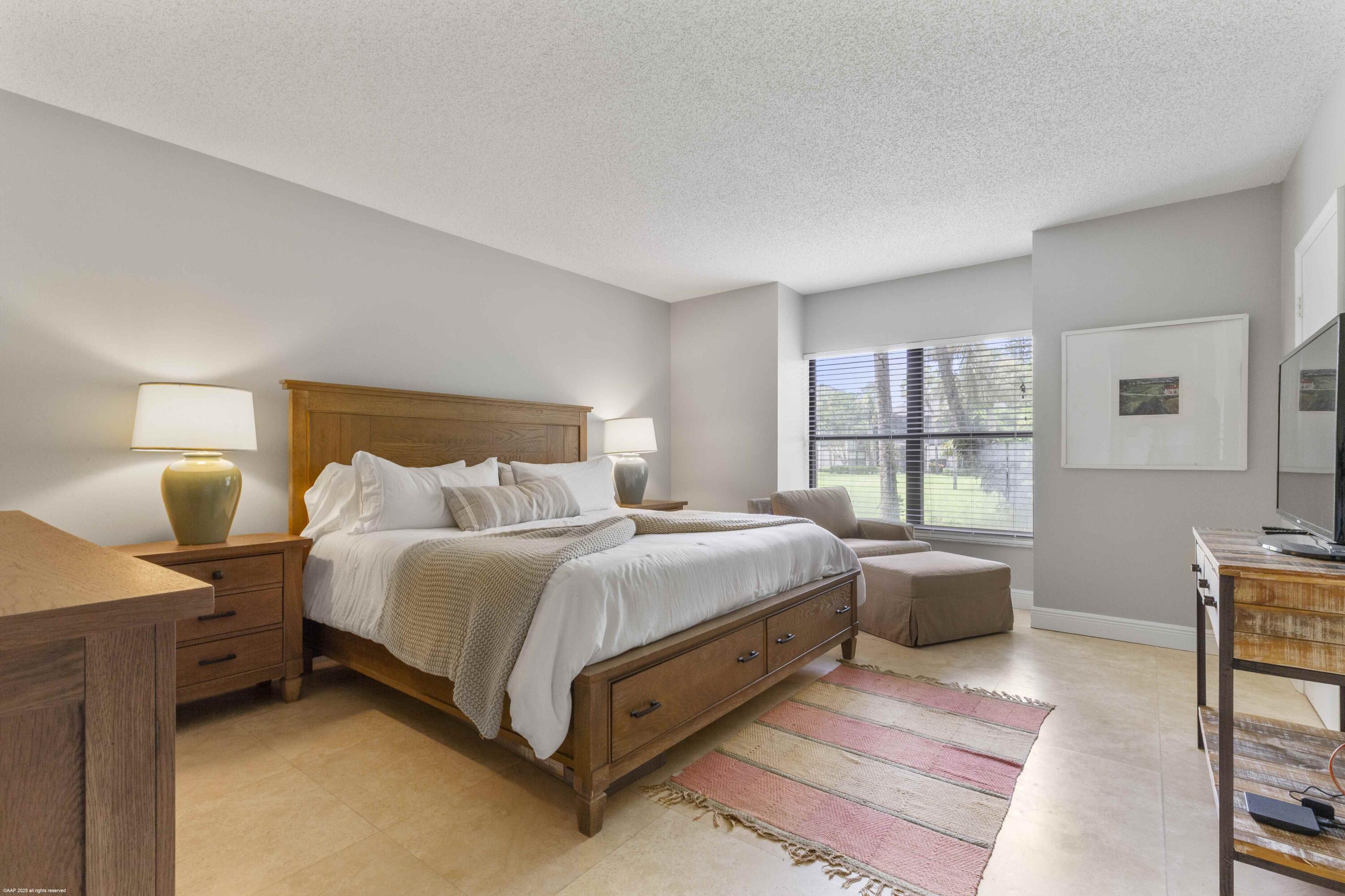 13329 Polo Club Road, Unit 105 Wellington, FL 33414 - Photo 19 of 43 a spacious bedroom with a bed and a window