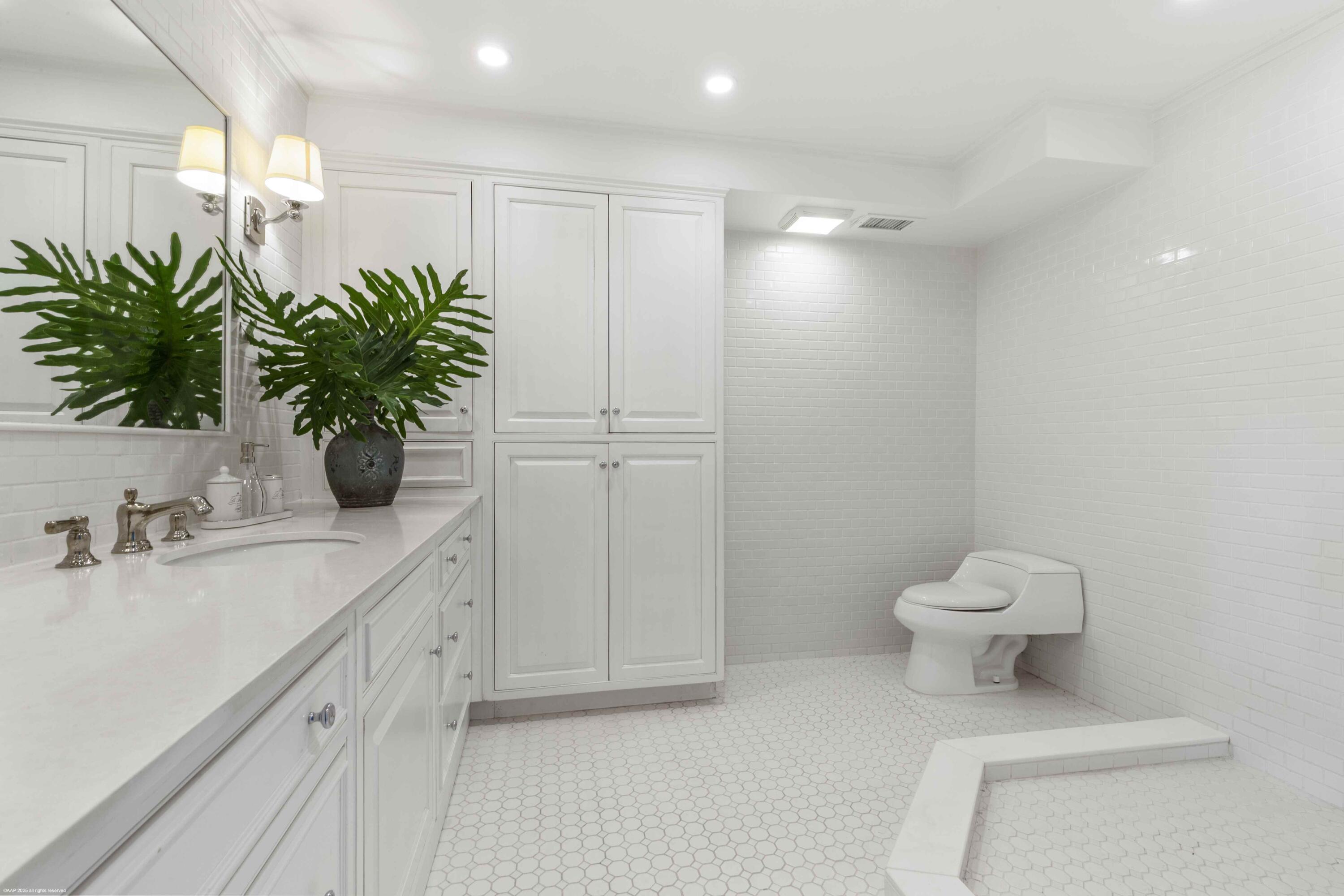 13329 Polo Club Road, Unit 105 Wellington, FL 33414 - Photo 20 of 43 a bathroom with a toilet a sink and mirror