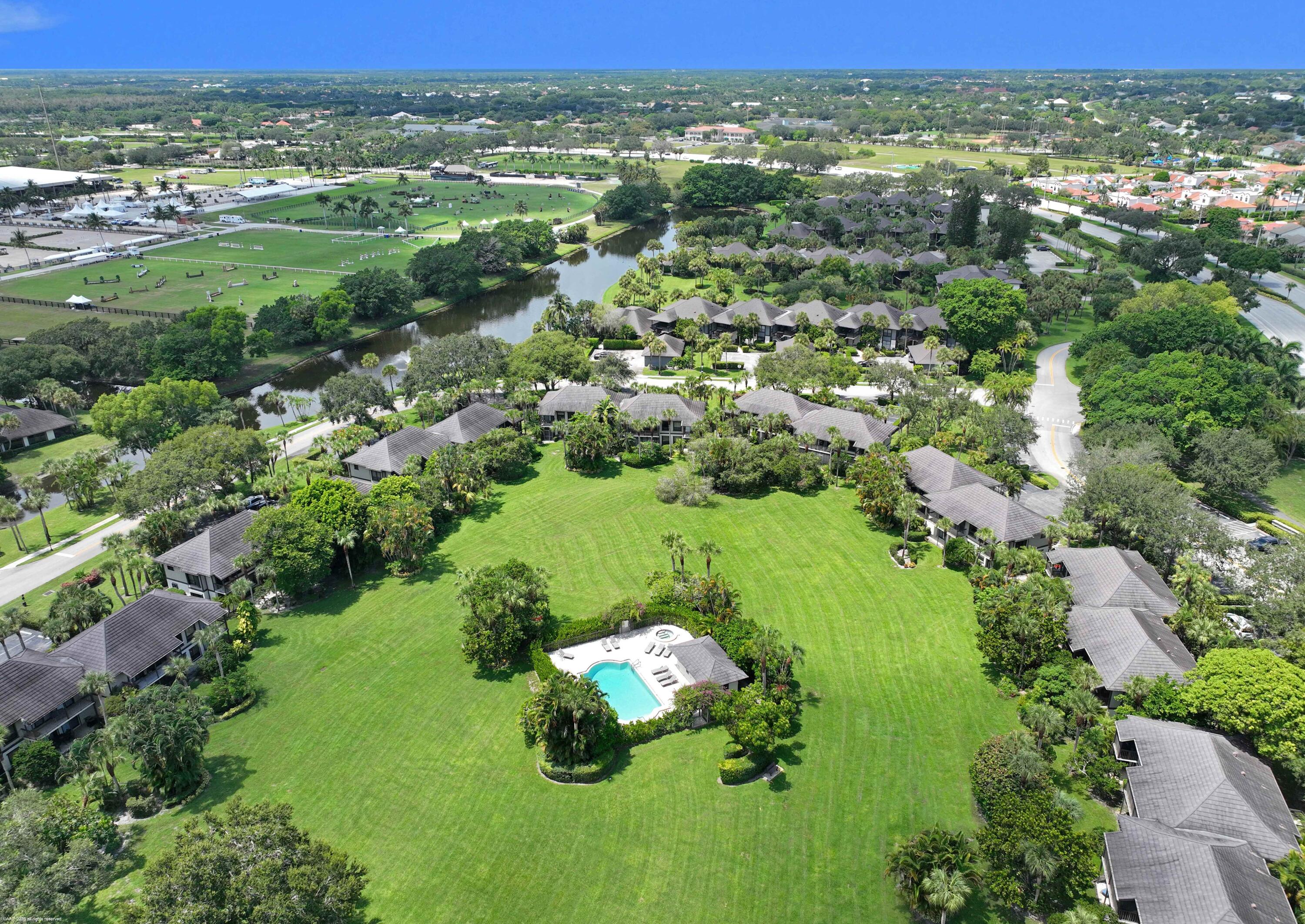 13329 Polo Club Road, Unit 105 Wellington, FL 33414 - Photo 2 of 43 an aerial view of residential houses with outdoor space and trees