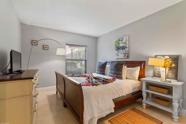 a bedroom with a bed and a dresser in it