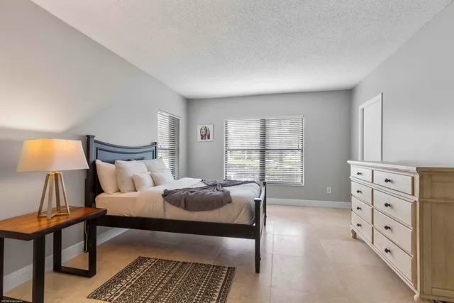 a bedroom with a bed and a lamp