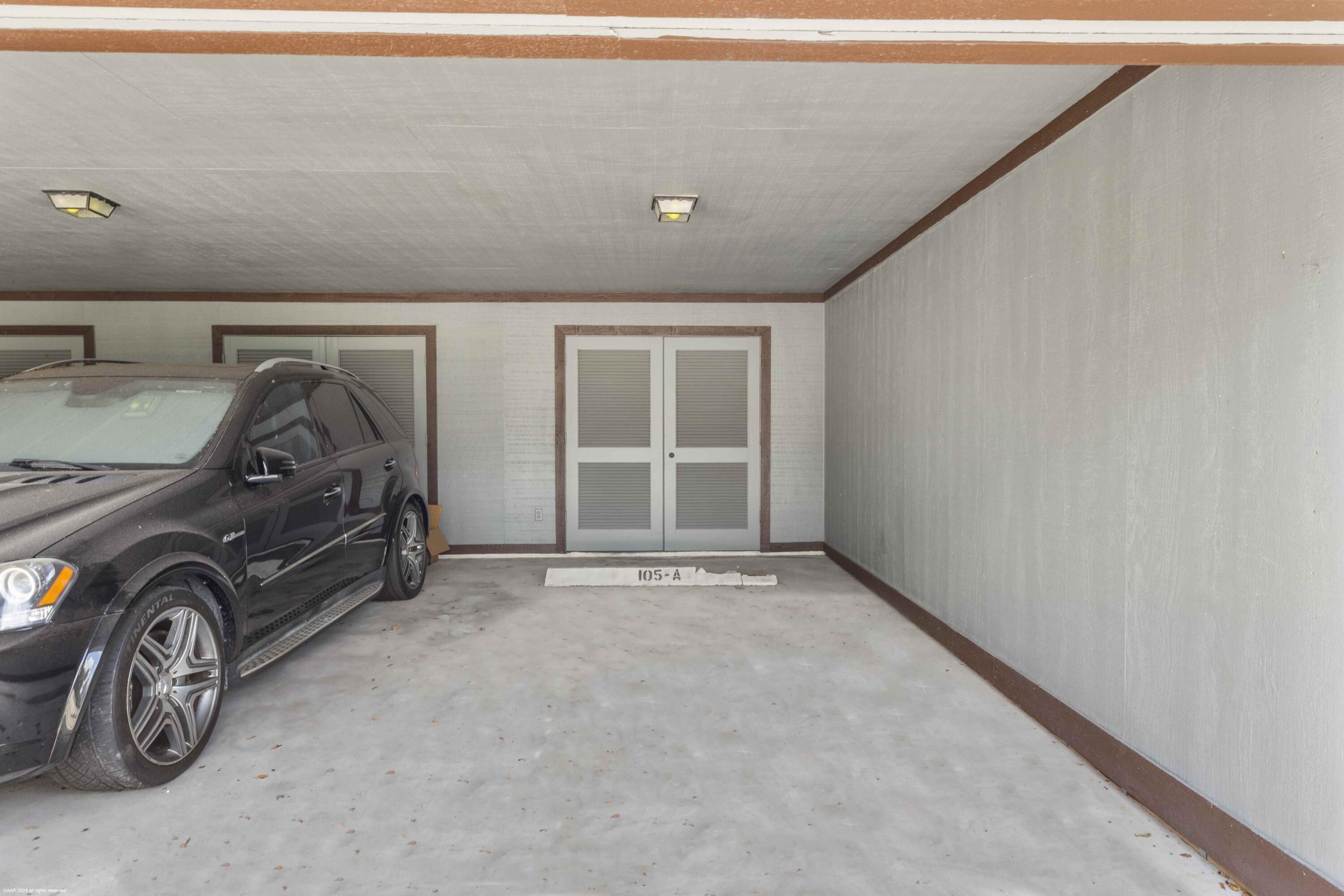13329 Polo Club Road, Unit 105 Wellington, FL 33414 - Photo 32 of 43 a view of a car in garage
