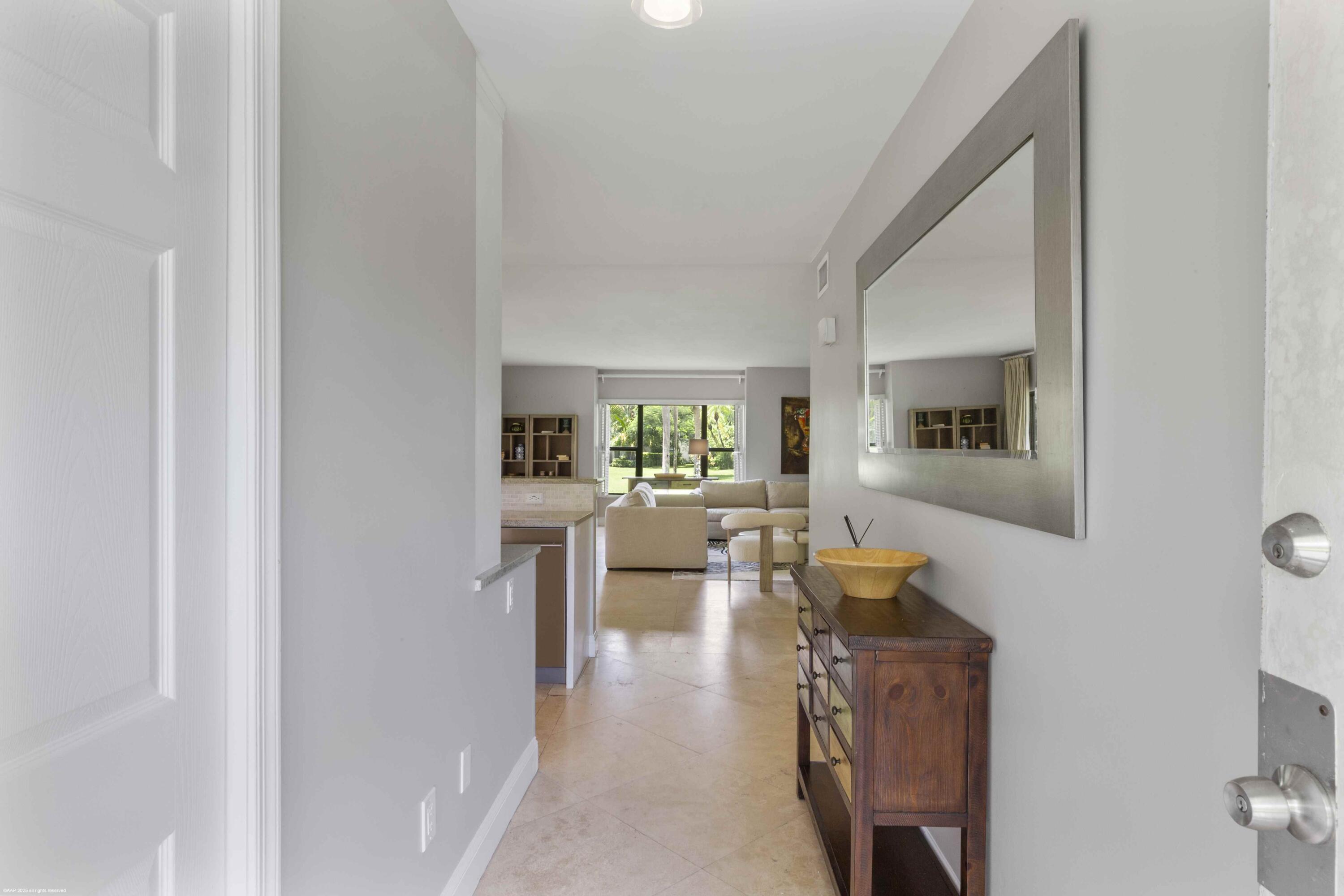 13329 Polo Club Road, Unit 105 Wellington, FL 33414 - Photo 7 of 43 a living room with furniture and a table