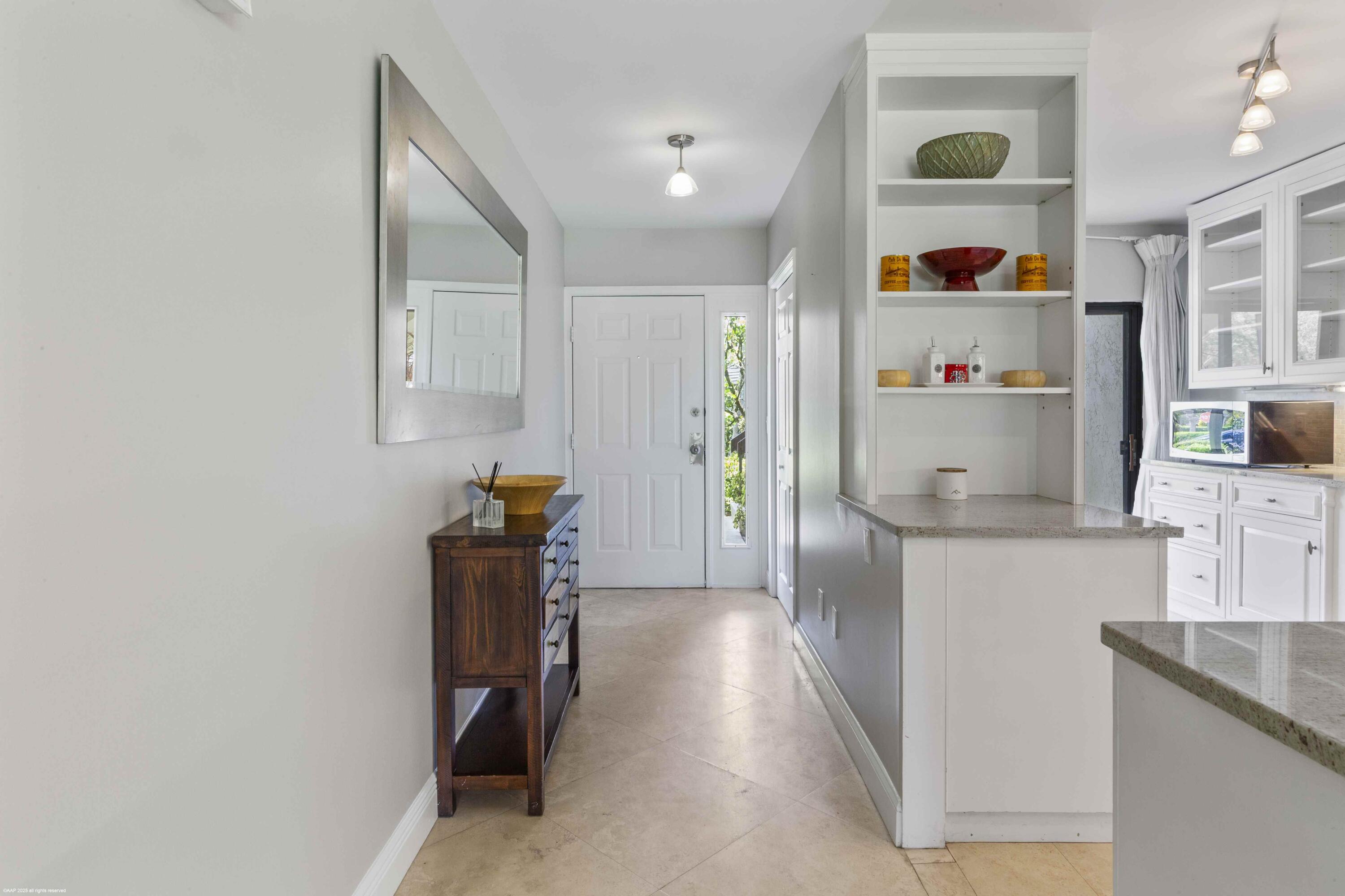 13329 Polo Club Road, Unit 105 Wellington, FL 33414 - Photo 8 of 43 a kitchen with refrigerator and window