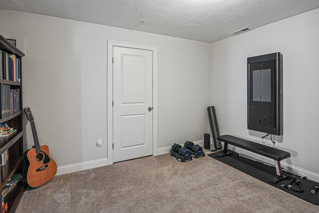 831 Ledgewood Way, Unit 831 Clinton, MA 01510 - Photo 13 of 41 a view of a room with gym equipment