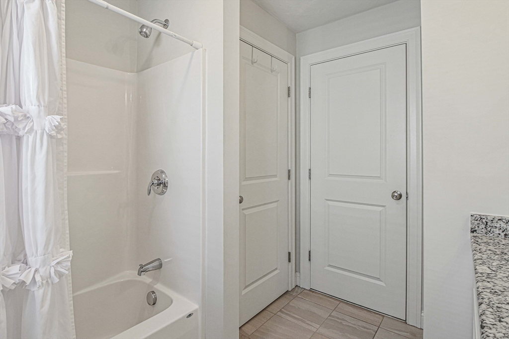 831 Ledgewood Way, Unit 831 Clinton, MA 01510 - Photo 15 of 41 a bathroom with a bathtub