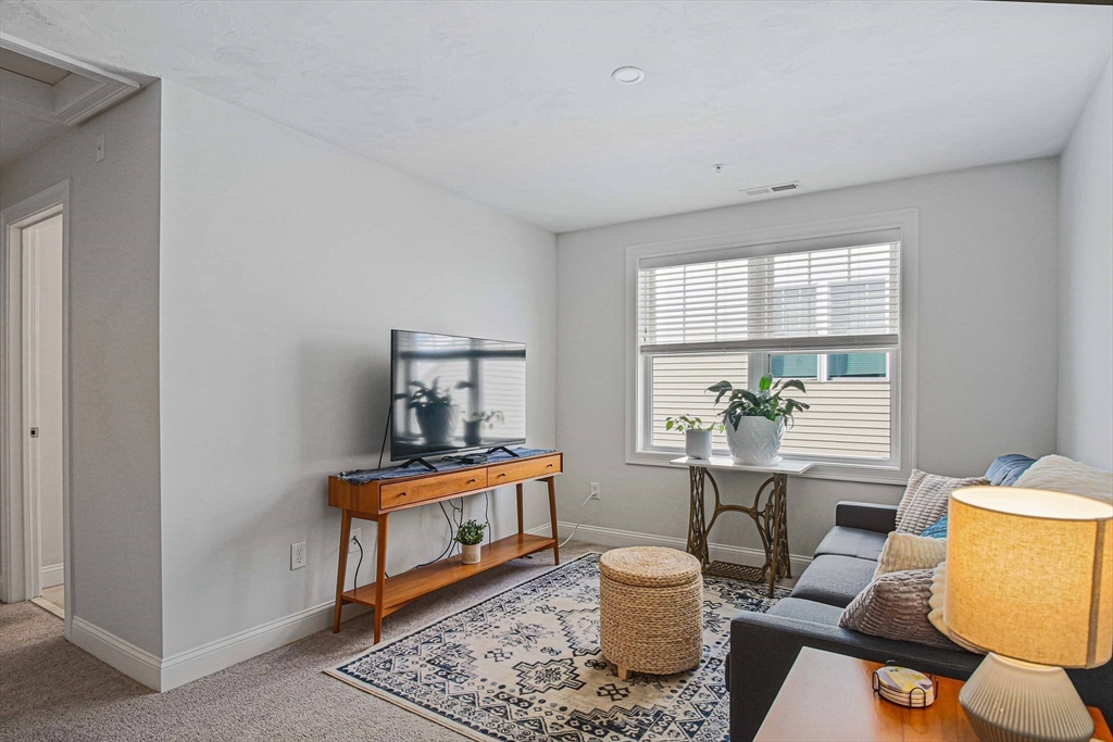 831 Ledgewood Way, Unit 831 Clinton, MA 01510 - Photo 18 of 41 a room with furniture and a window